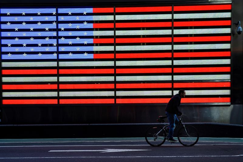 &copy; Reuters. A bicyclist rides through Times Square during evening rush hour in New York