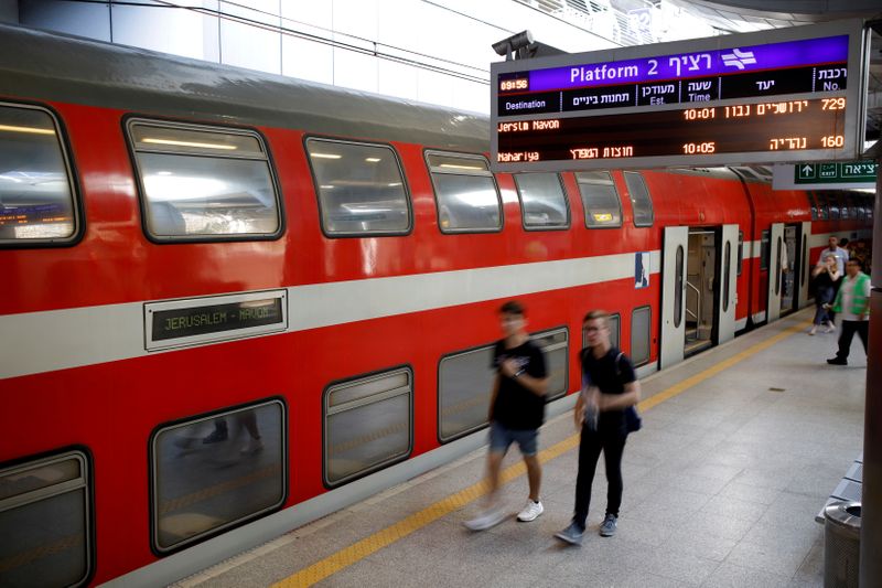 © Reuters. People walk on the platform at Israel's new high-speed rail line station at Ben Gurion International Airport, in Lod