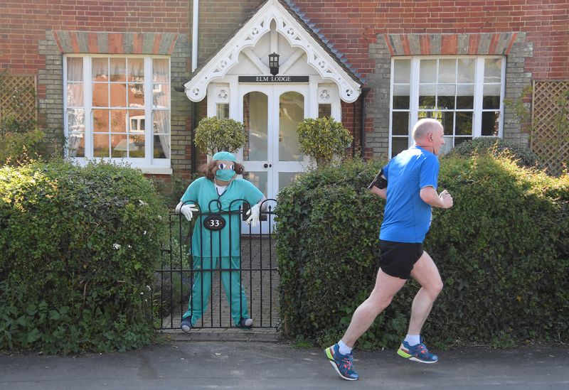 &copy; Reuters. Scarecrows representing key workers lighten the daily lockdown walk, as the number of the coronavirus disease cases (COVID-19) grows around the world, in the village of Capel