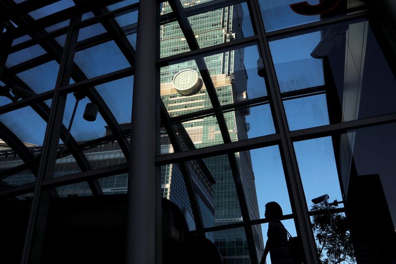 &copy; Reuters. A woman walks under Taiwan&apos;s landmark building Taipei 101