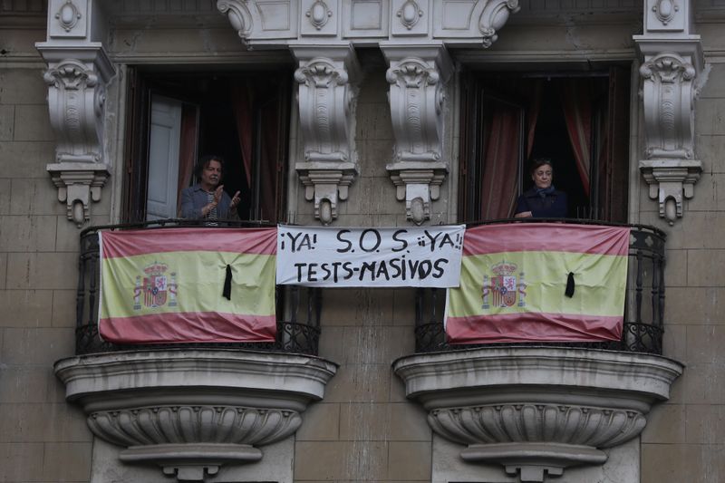 &copy; Reuters. Pessoas em varandas em prédio de Madri durante quarentena do coronavírus