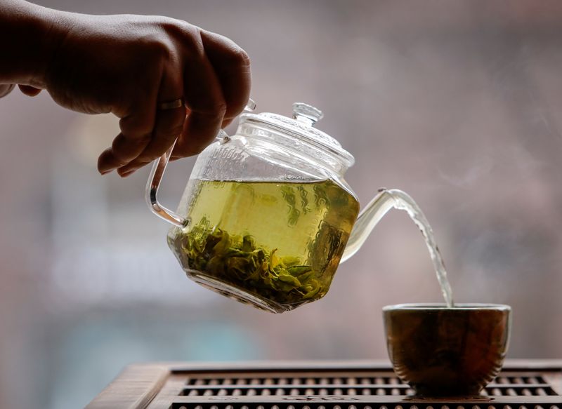 &copy; Reuters. The owner of a tea house pours a cup of tea in this picture illustration