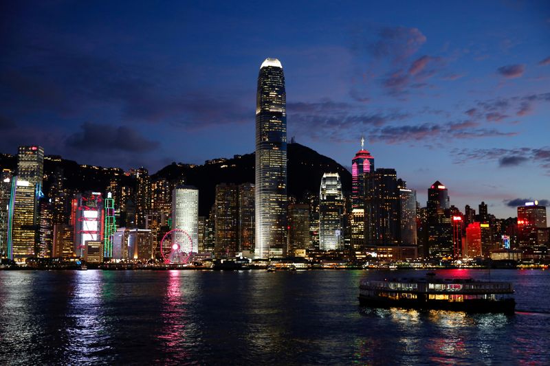 © Reuters. FILE PHOTO: A Star Ferry boat crosses Victoria Harbour in front of a skyline of buildings during sunset, as a meeting on national security legislation takes place in Hong Kong