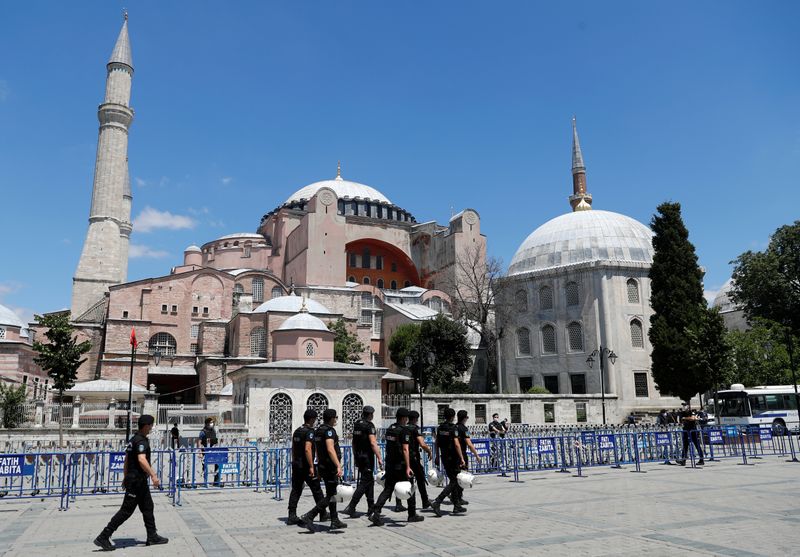 &copy; Reuters. Police officers walk in front of Hagia Sophia, or Ayasofya-i Kebir Camii, in Istanbul