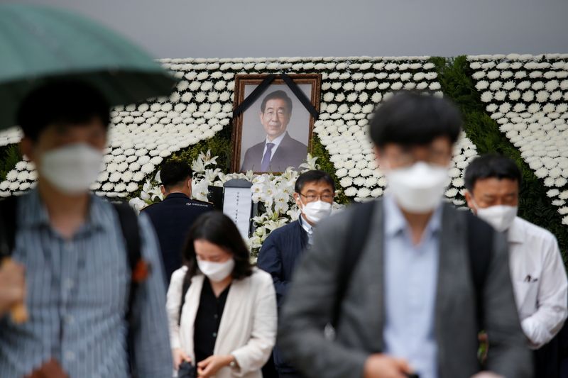 &copy; Reuters. People react as they walk by a memorial altar for late Seoul Mayor Park Won-soon at Seoul City Hall Plaza in Seoul