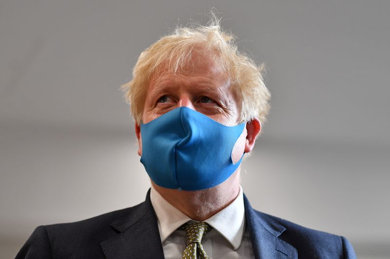 &copy; Reuters. Britain&apos;s Prime Minister Boris Johnson, wearing a face mask, visits headquarters of the London Ambulance Service NHS Trust in London