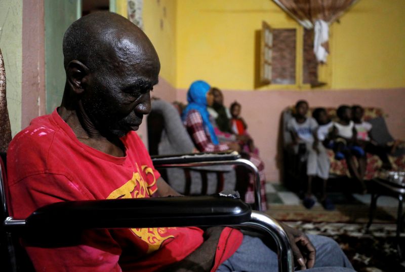 &copy; Reuters. Sudanese refugee family sits in their living room in Ain Shams district, amid concerns about the spread of the coronavirus disease (COVID-19), in Cairo