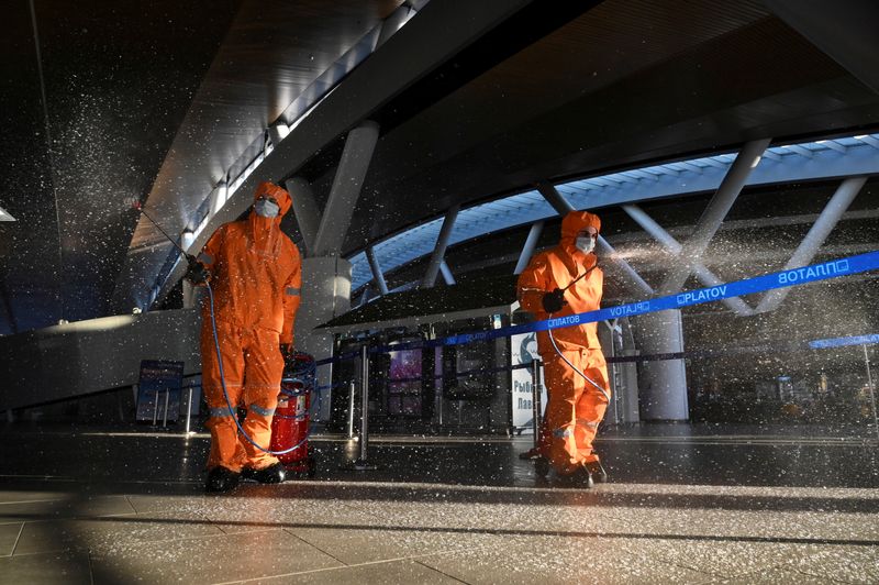 &copy; Reuters. FILE PHOTO: Specialists sanitize an airport near Rostov-on-Don