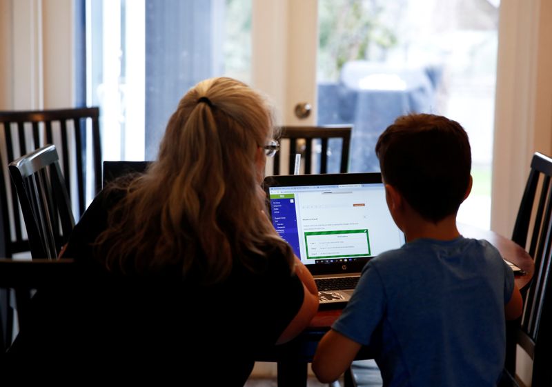 &copy; Reuters. FILE PHOTO: Miller, a 4th grader at Cottage Lake Elementary, works with his grandmother Brackett as they try to figure out how to navigate the online learning system the Northshore School District will use for two weeks due to coronavirus concerns, at Bra