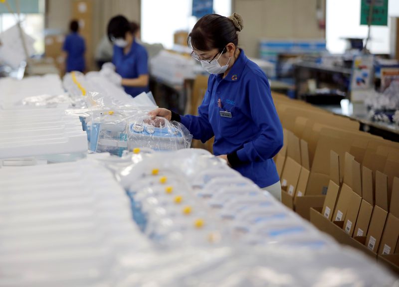 &copy; Reuters. FILE PHOTO: An employee of Sanko Manufacturing Co. conducts shipping operations of the company&apos;s ventilators as the spread of the coronavirus disease (COVID-19) continues in Saitama