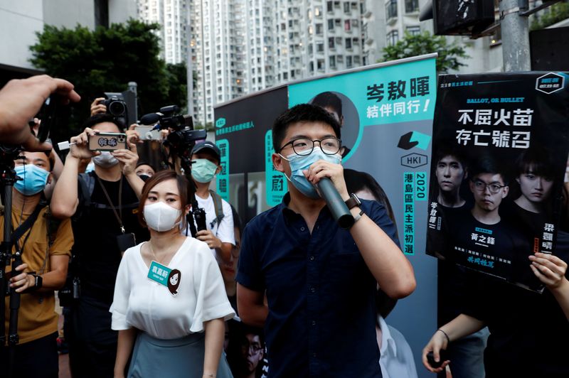 &copy; Reuters. FILE PHOTO: Pro-democracy activists Tiffany Yuen Ka-wai and Joshua Wong attend a campaigning during primary elections aimed for selecting democracy candidates, in Hong Kong