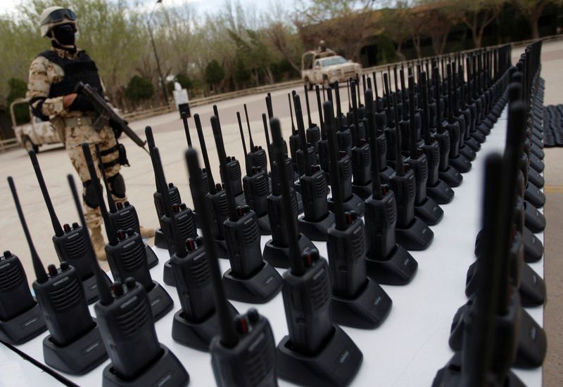 &copy; Reuters. FILE PHOTO: An armed soldier stands guard next to communication radios displayed to the media at a military base in Ciudad Juarez