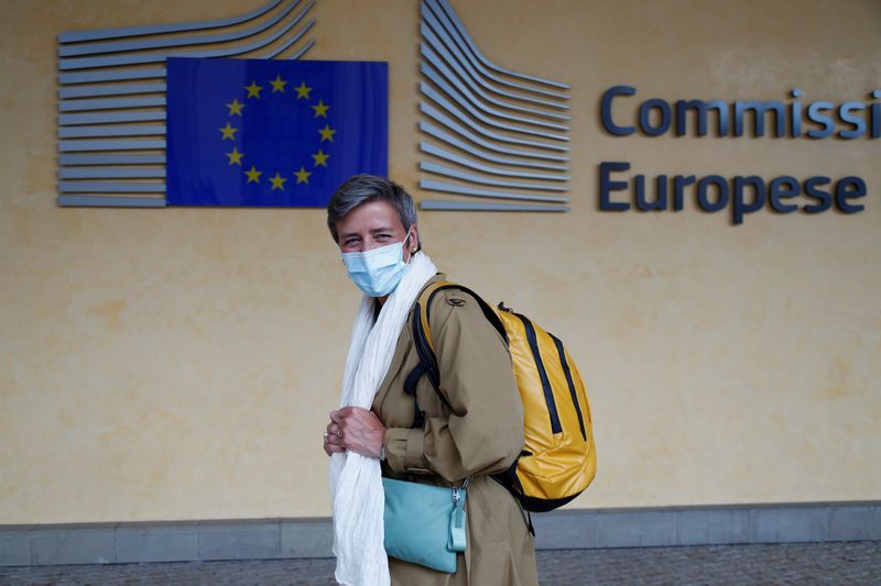 © Reuters. European Competition Commissioner Margrethe Vestager wearing a protective mask leaves the EU Commission headquarters in Brussels