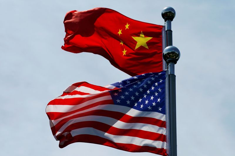 &copy; Reuters. Chinese and U.S. flags flutter near The Bund in Shanghai