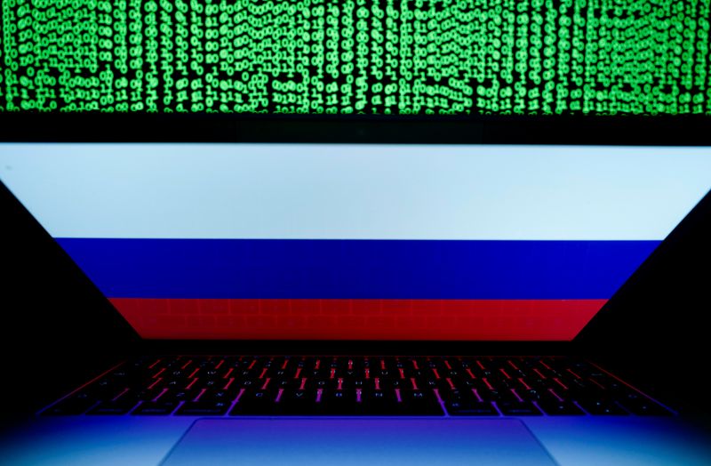 &copy; Reuters. FILE PHOTO: Russian flag is seen on the laptop screen in front of a computer screen on which cyber code is displayed, in this illustration picture