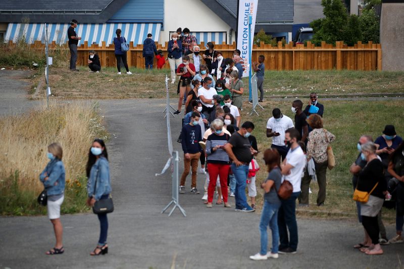 &copy; Reuters. Pessoas com máscaras fazem fila para passar por exame de detecção de Covid-19 em Laval, na França