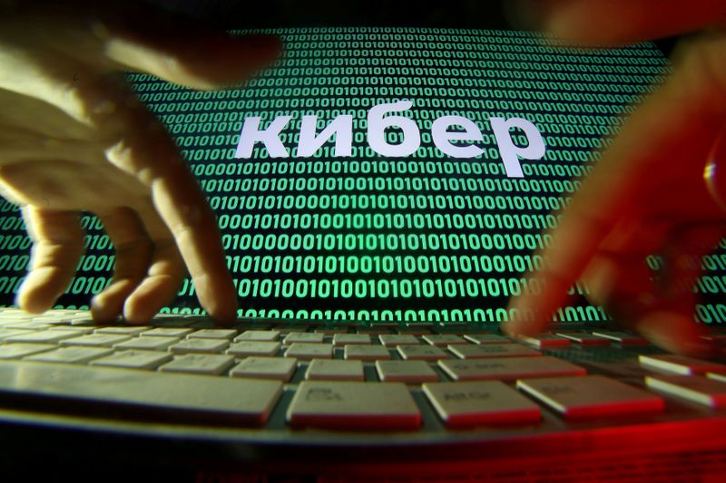 &copy; Reuters. FILE PHOTO: Hands are seen on a keyboard in front of a displayed cyber code in this picture illustration