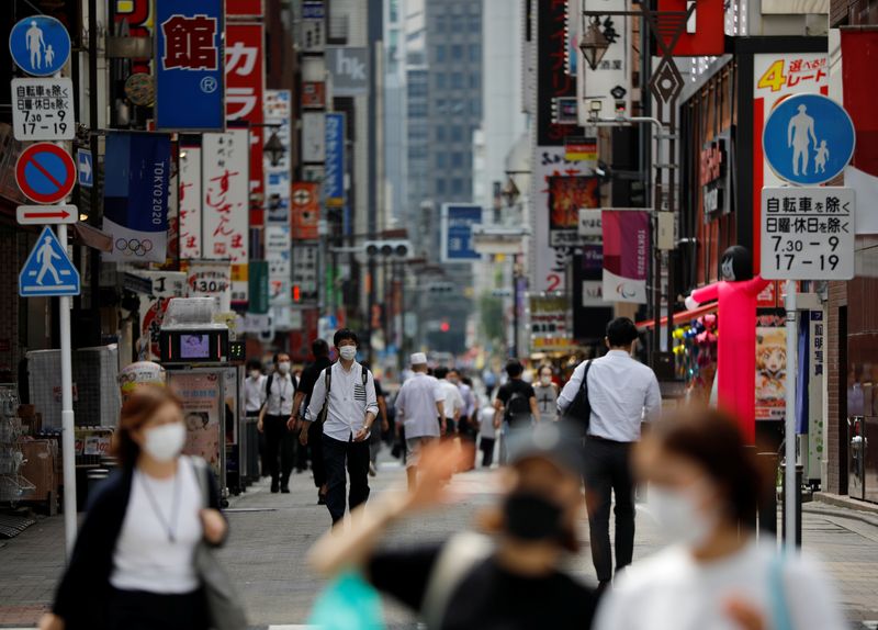 © Reuters. Passersby wearing protective face masks are seen on the street amid the coronavirus disease (COVID-19) outbreak, in Tokyo
