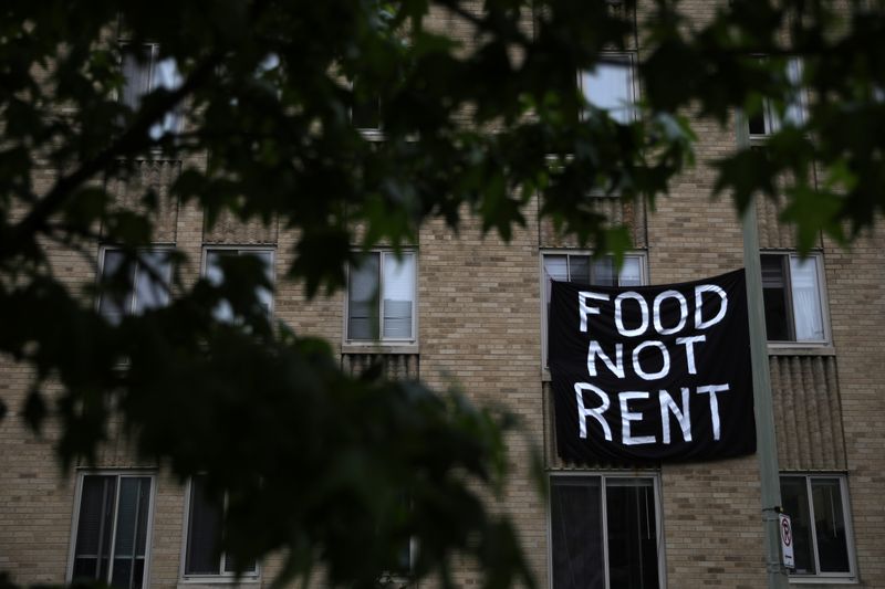 &copy; Reuters. Makeshift sheets displaying messages of protest contesting the ability to pay for rent hang in the window of an apartment building in the Columbia Heights neighborhood in Washington