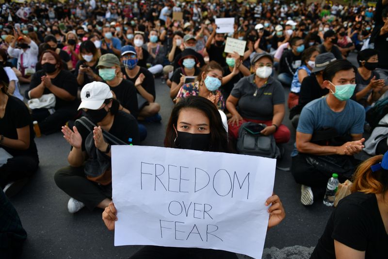 &copy; Reuters. A protester holds a sign during a protest demanding the resignation of the government in Bangkok