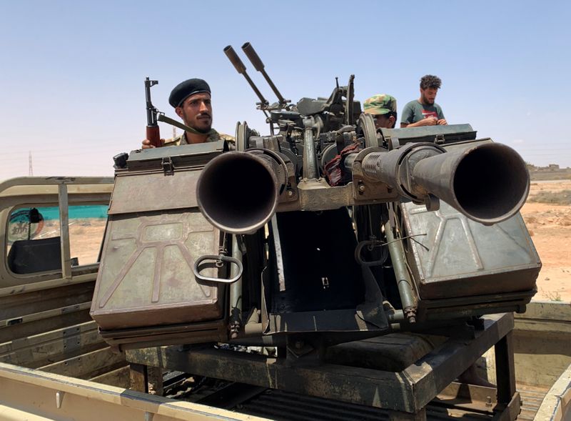 &copy; Reuters. A member of the troops loyal to Libya&apos;s internationally recognized government rides a military vehicle as he prepares before heading to Sirte, on the outskirts of Misrata