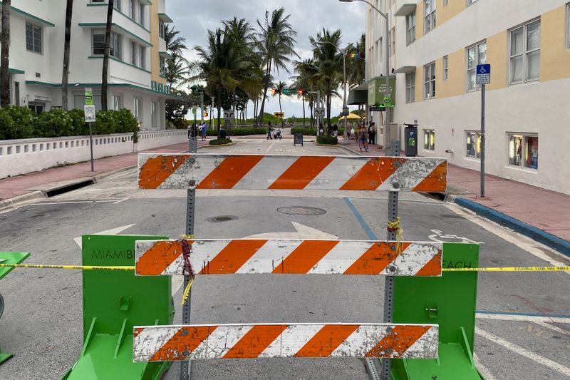&copy; Reuters. A barrier blocks a street prior to the 8 pm curfew in Miami Beach