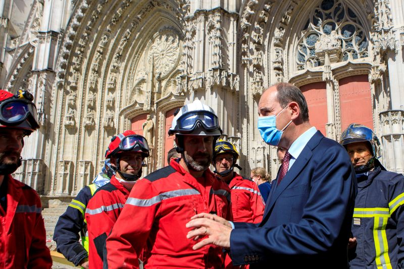 &copy; Reuters. French Prime Minister Jean Castex wears a protective mask as he meets firefighters after the blaze at the Cathedral of Saint Pierre and Saint Paul in Nantes