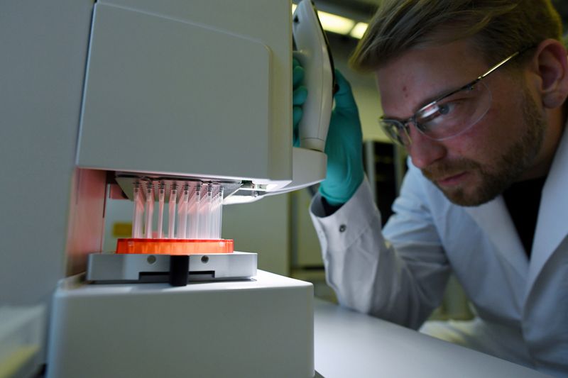 © Reuters. FILE PHOTO: Employee Philipp Hoffmann, of German biopharmaceutical company CureVac, demonstrates research workflow on a vaccine for the coronavirus (COVID-19) disease at a laboratory in Tuebingen