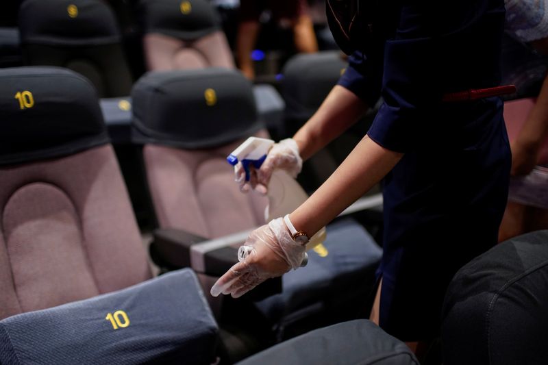 &copy; Reuters. A staff member disinfects seats in a cinema as it reopens following the coronavirus disease (COVID-19) outbreak, in Shanghai