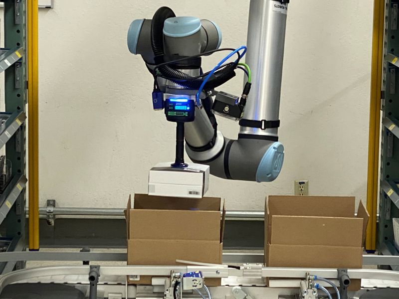 &copy; Reuters. A collaborative robot, or cobot, places an item in a box at California-based DCL Logistics facility in Freemont