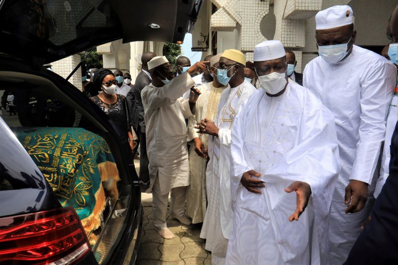 © Reuters. FILE PHOTO: Ivory Coast President Alassane Ouattara is seen near the coffin of Ivory Coast's late Prime Minister Amadou Gon Coulibaly during his funeral ceremony at Riviera Golf's Mosque in Abidjan