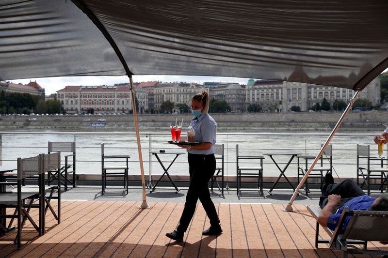 &copy; Reuters. A crew member brings drinks at onboard the NickoVision river cruise boat following the coronavirus disease (COVID-19) outbreak in Budapest