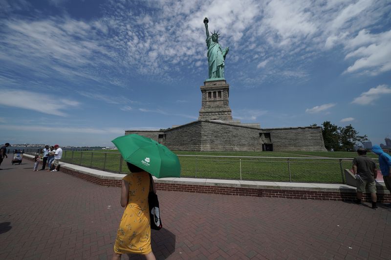 &copy; Reuters. People are seen at the Statue of Liberty as New York enters Phase 4 of reopening following the outbreak of the coronavirus disease (COVID-19) in New York City