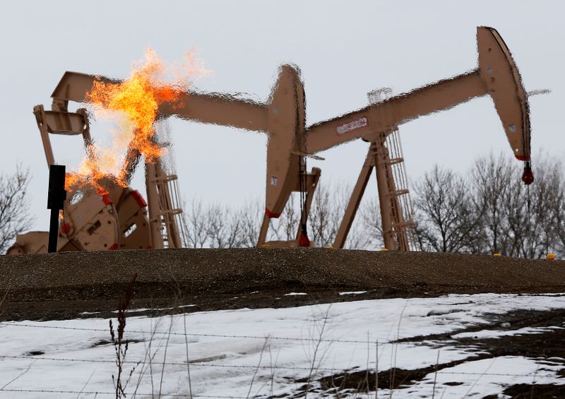 &copy; Reuters. Natural gas flares are seen at an oil pump site outside of Williston, North Dakota