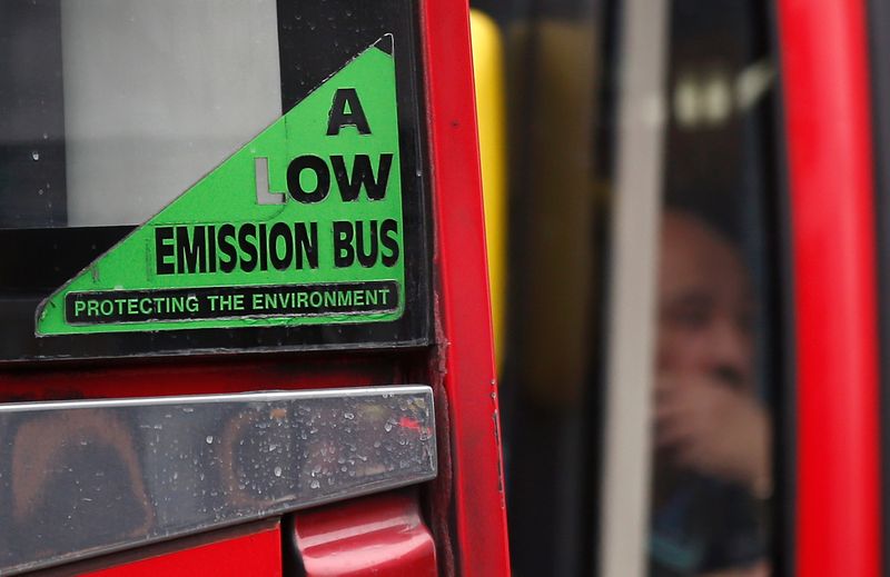 &copy; Reuters. A bus with a sign advertising its reduced emissions is driven through Richmond in London