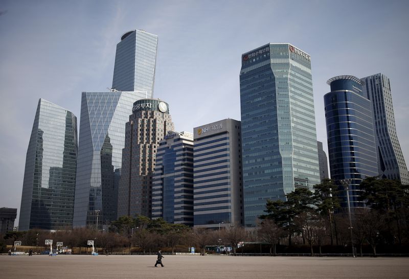 &copy; Reuters. A man walks in a park at a business district in Seoul
