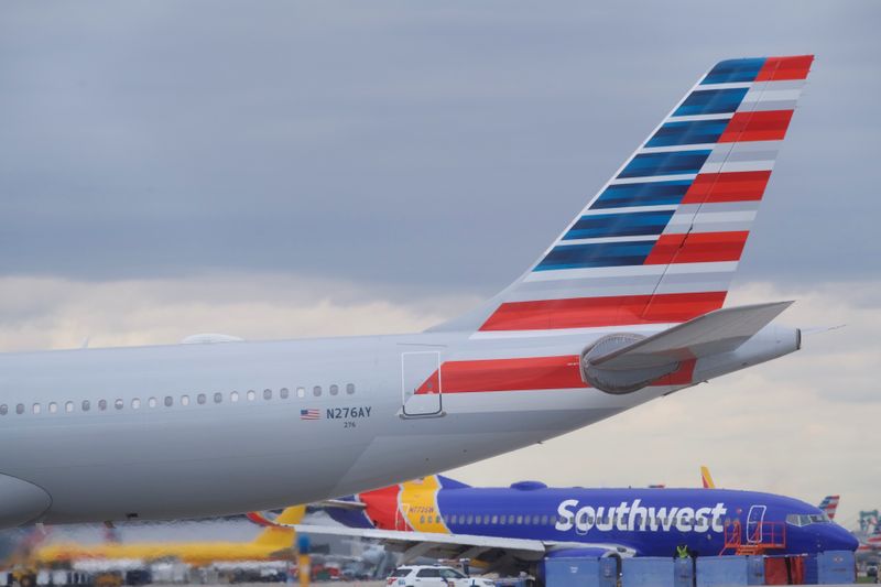 &copy; Reuters. An airplane passes in front of Southwest Airlines Flight 1380, which diverted to the Philadelphia International Airport this morning after the airline crew reported damage to one of the aircraft&apos;s engines, on a runway in Philadelphia, Pennsylvania