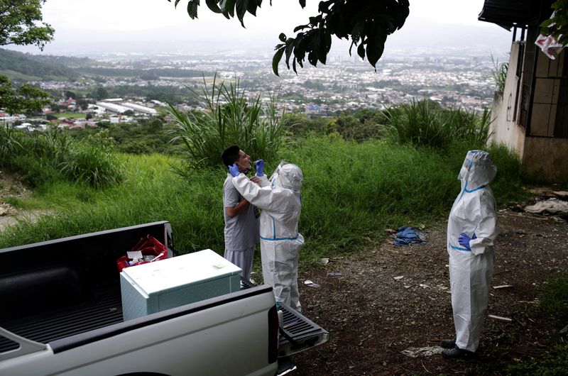 &copy; Reuters. Foto de archivo. Un trabajador de la salud toma una muestra de un hombre para la prueba del coronavirus en San José
