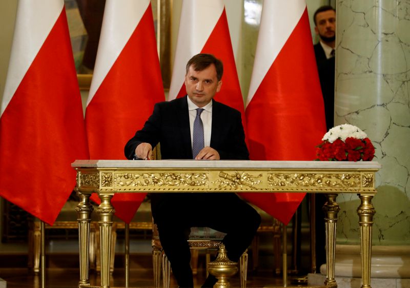 &copy; Reuters. FILE PHOTO: Zbigniew Ziobro signs documents after being designated as Minister of Justice, at the Presidential Palace in Warsaw