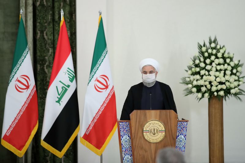 &copy; Reuters. Iranian President Hassan Rouhani attends a news conference with Iraqi Prime Minister Mustafa al-Kadhimi as he wears a protective mask, in Tehran