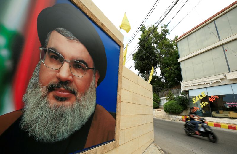 &copy; Reuters. FILE PHOTO: A man rides a motorbike past a picture of Lebanon&apos;s Hezbollah leader Sayyed Hassan Nasrallah, near Sidon