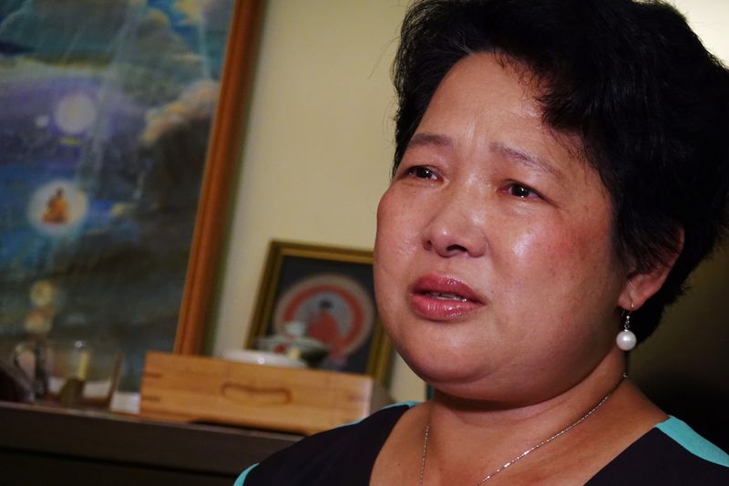 &copy; Reuters. Yang Xiaolan cries during an interview at her home in Hong Kong