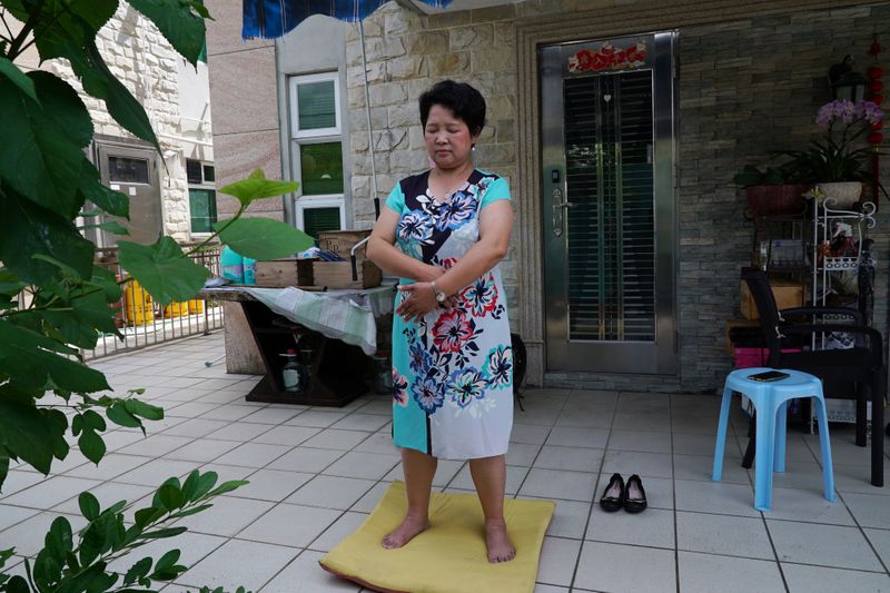 &copy; Reuters. Yang Xiaolan practises Falun Gong at her backyard during an interview in Hong Kong