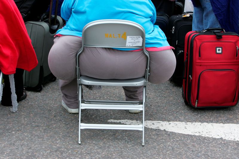 &copy; Reuters. FILE PHOTO: A passenger waits for a delayed flight at Heathrow airport&apos;s terminal four in London