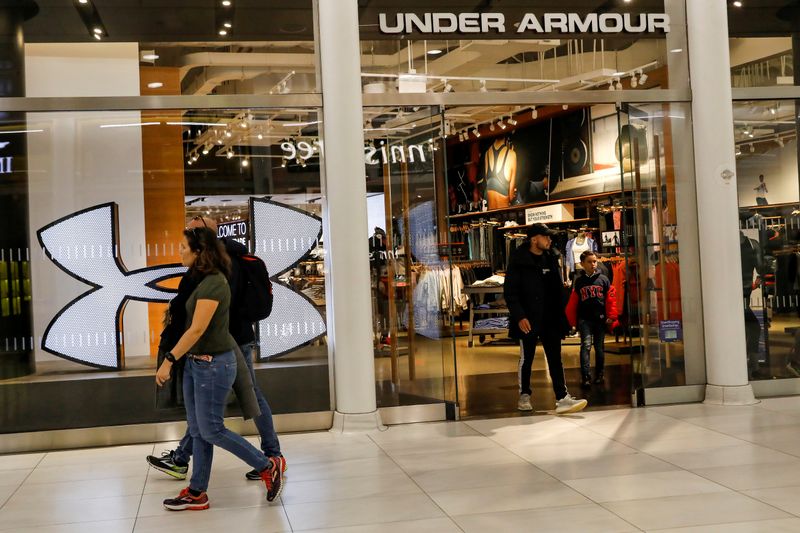 © Reuters. FILE PHOTO: Customers exit an Under Armour store in New York