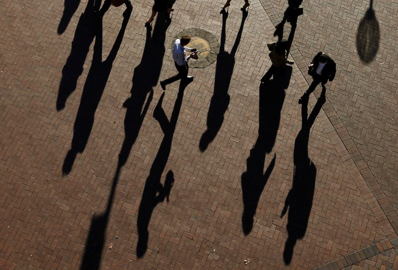 &copy; Reuters. Commuters cast their shadows as they arrive at the Central Business District during the morning rush hour in Sydney