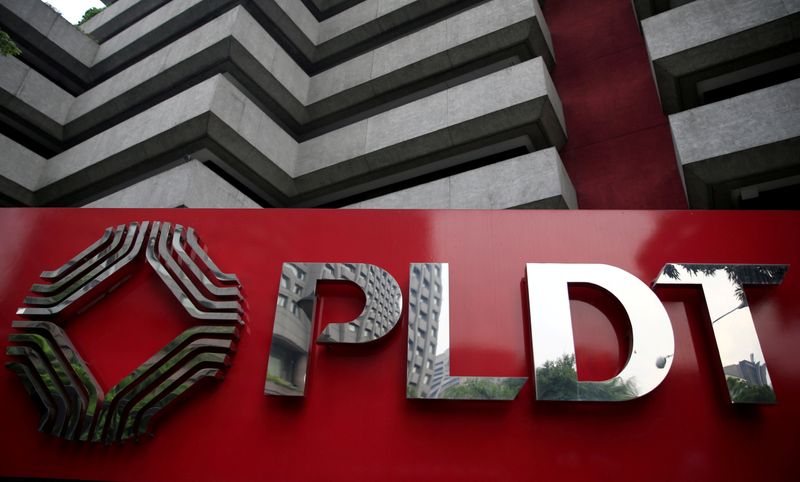 © Reuters. FILE PHOTO: A logo of Philippine Long Distance Telephone Company (PLDT) is seen in front of their building in Makati city, metro Manila, Philippines