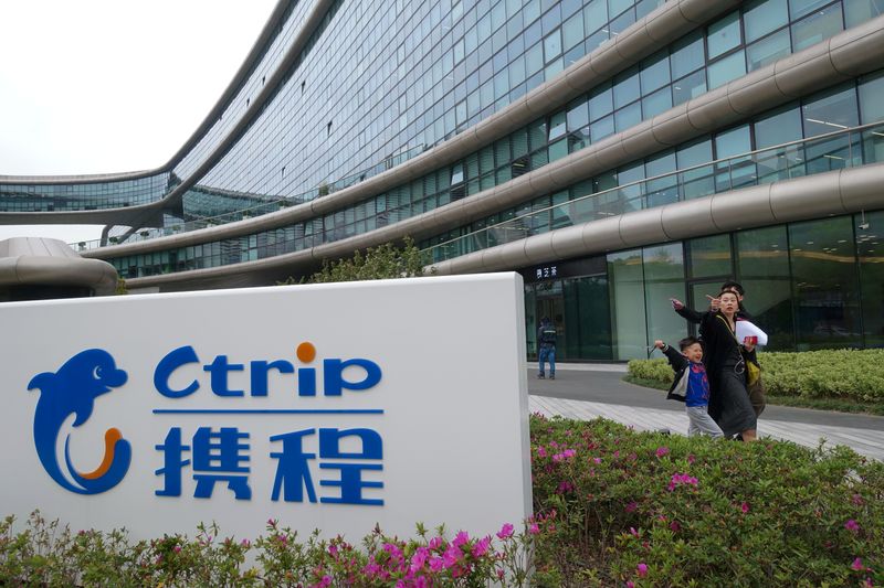 &copy; Reuters. People walk by the logo of online travel firm Ctrip.Com International Ltd at its headquarters in Shanghai
