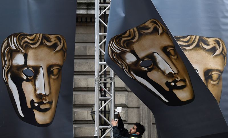 &copy; Reuters. FILE PHOTO: An event worker attaches set parts during preparations for the BAFTA awards ceremony in London