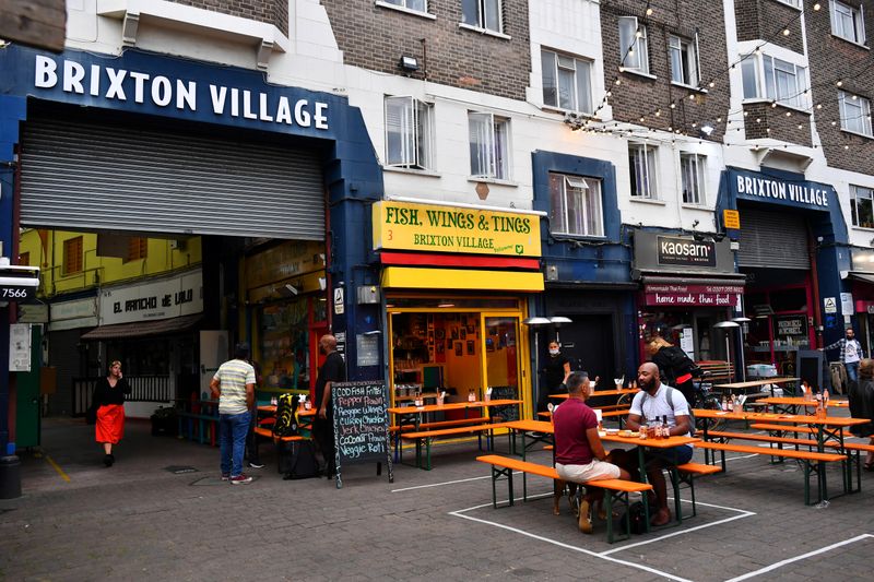 © Reuters. Empty tables are seen during a quiet night at Brixton Village in London